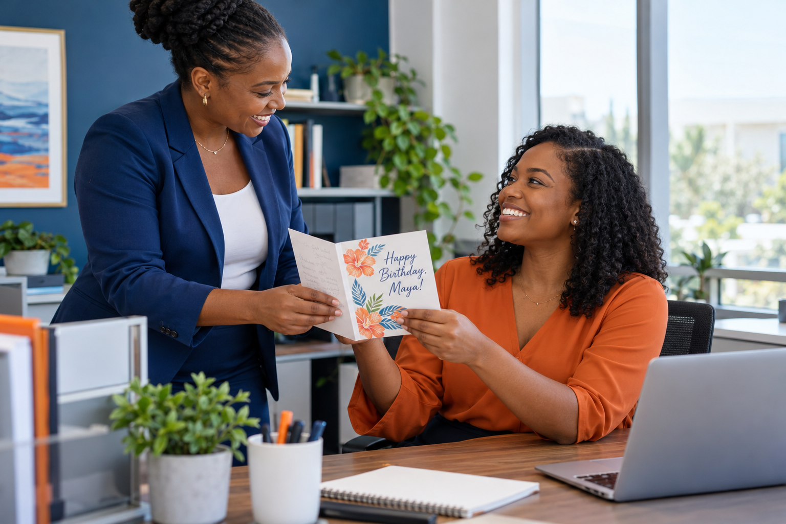An HR colleague presents an employee with a personalised birthday card